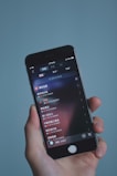 Hands holding a smartphone showing the Winter Sonata music player with a track preview