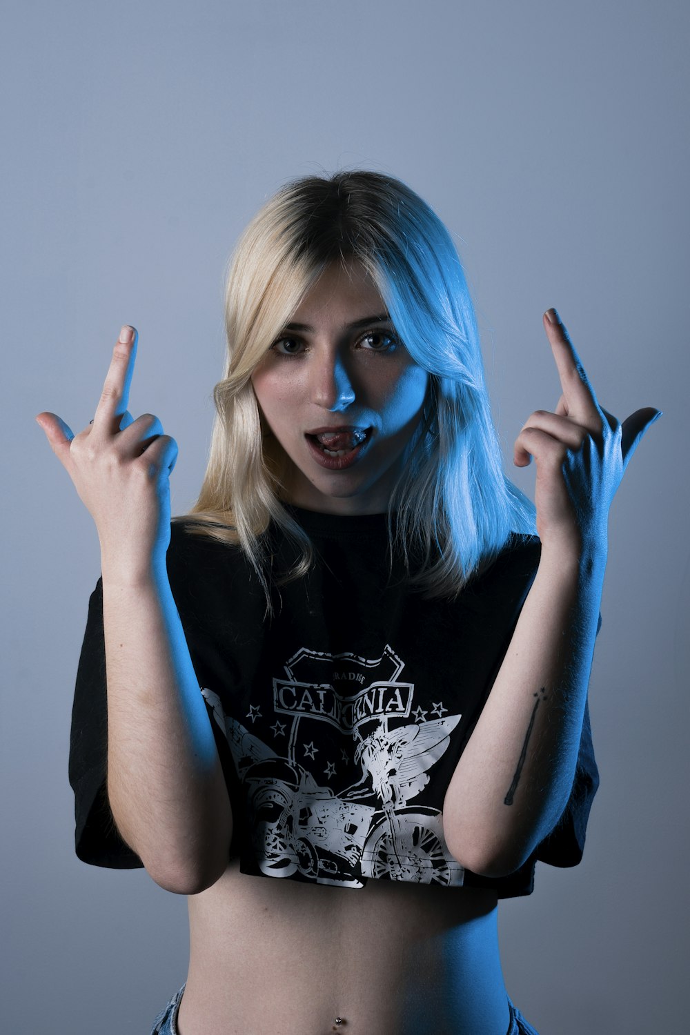 woman in black and white crew neck t-shirt with blue hair