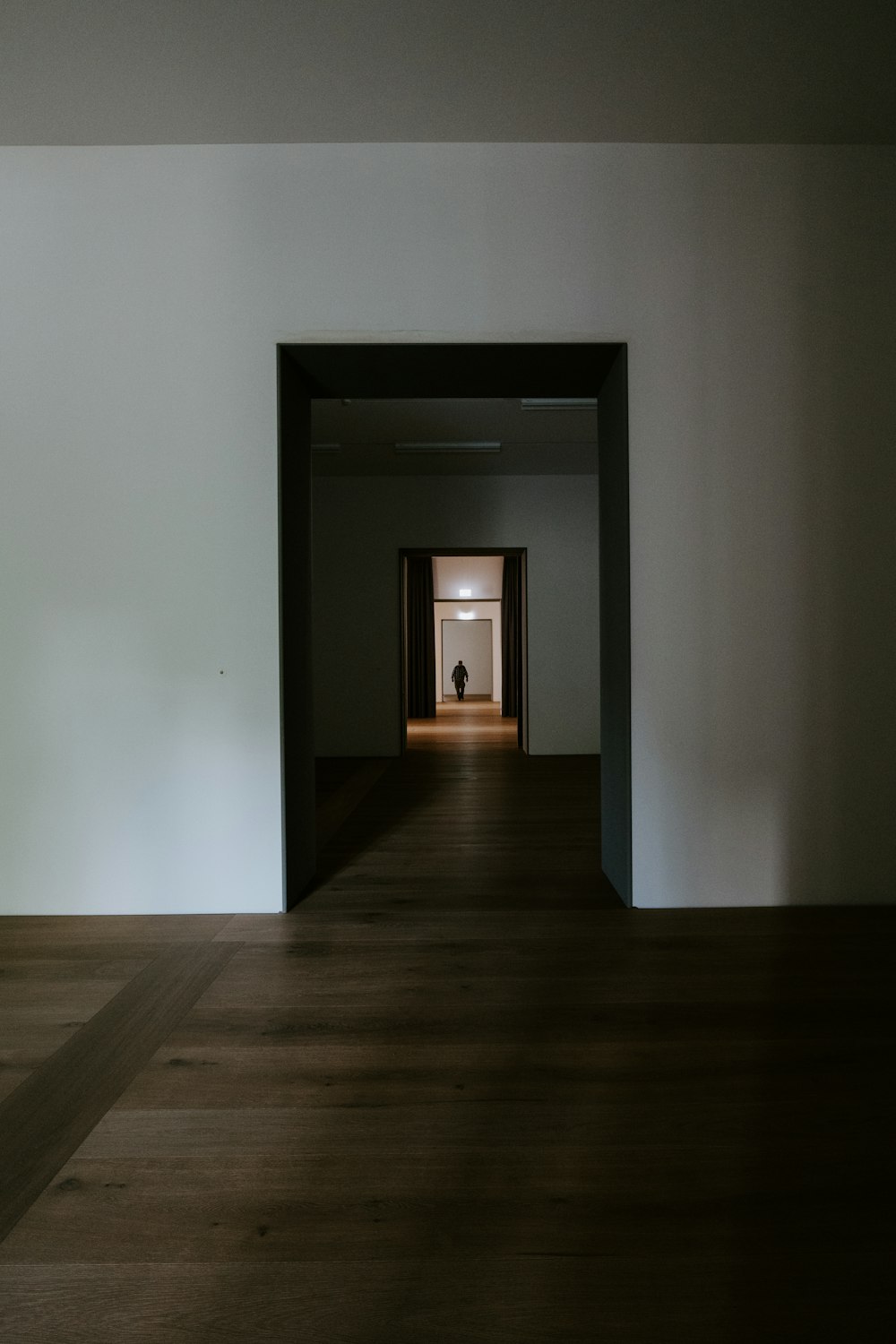 brown wooden floor with white wall