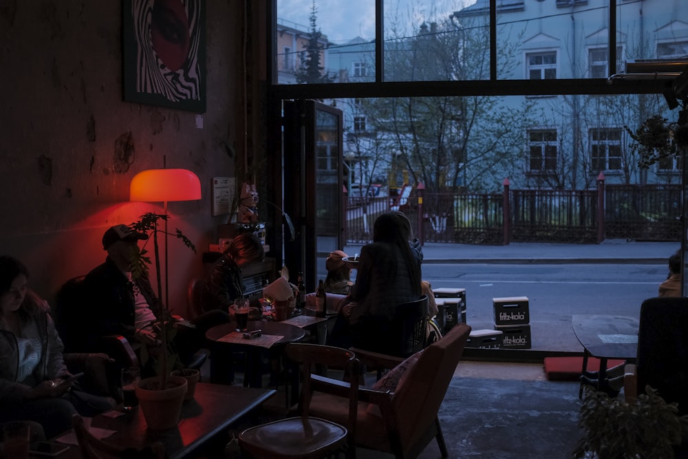 people sitting on chairs near window during daytime