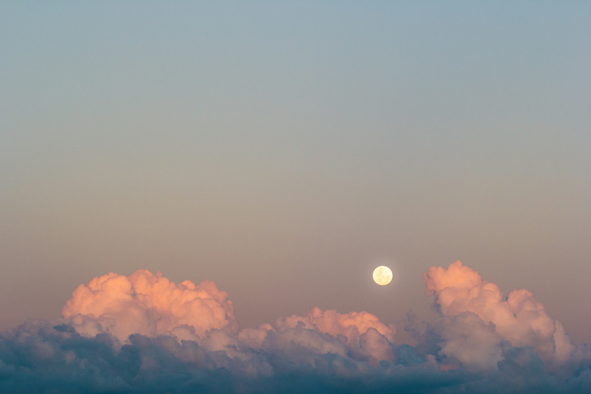 A whimsical illustration of a burger-shaped moon, casting a soft light over a dreamy landscape.