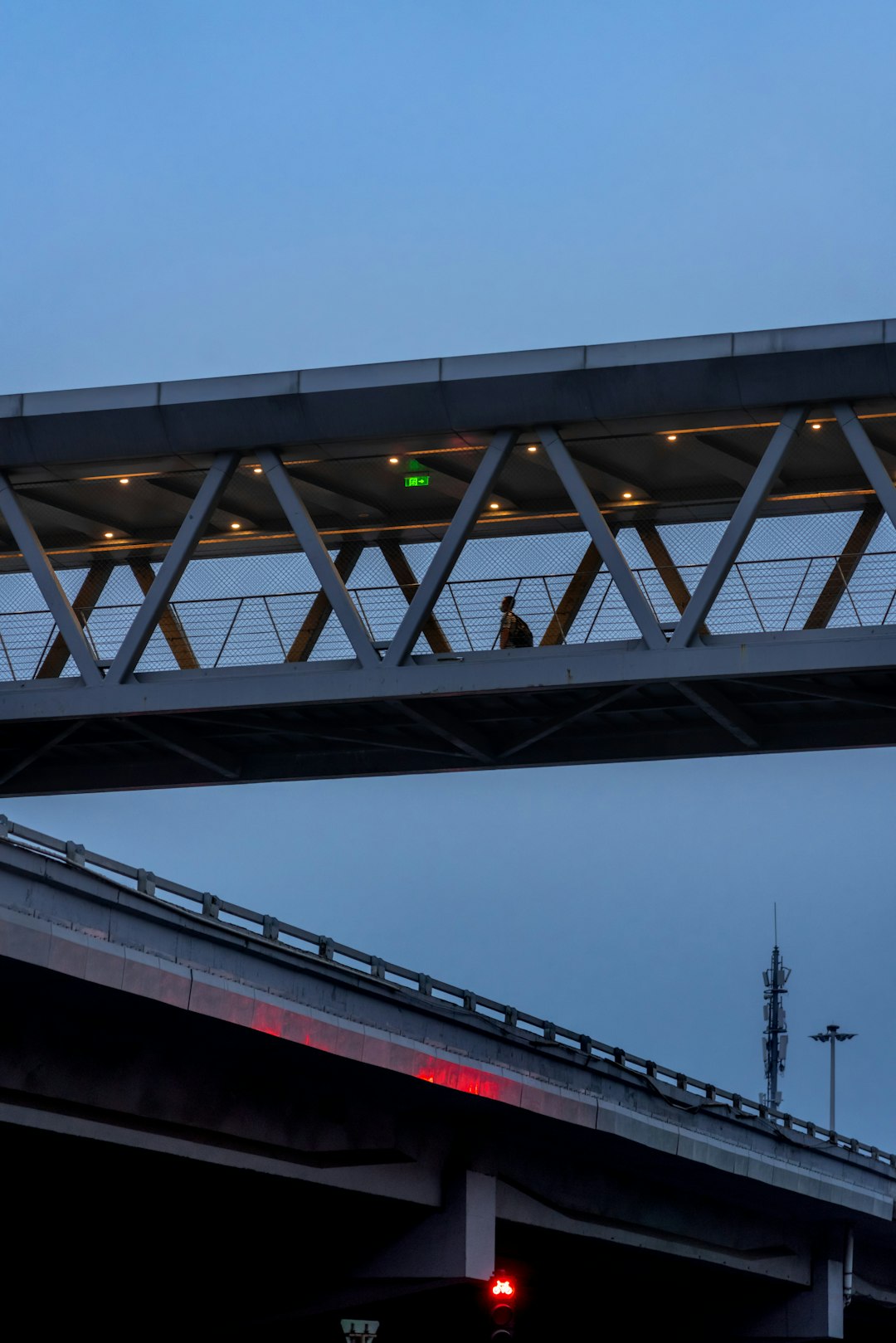 red and white bridge under gray sky