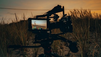 black video camera on tripod