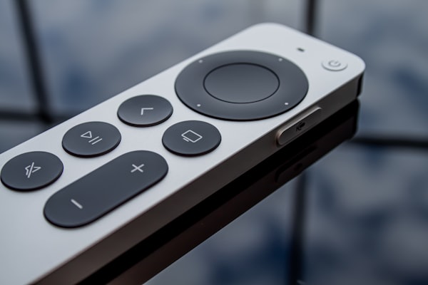 a sleek remote control on a glass table top