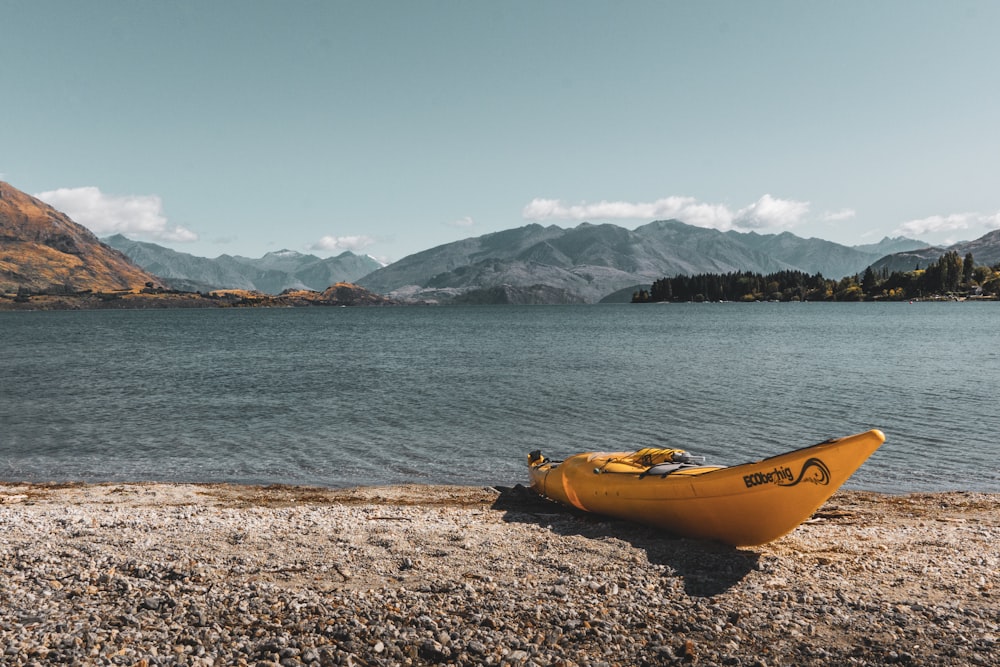 yellow kayak on shore during daytime