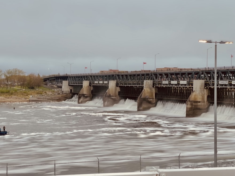 white water dam under white sky during daytime