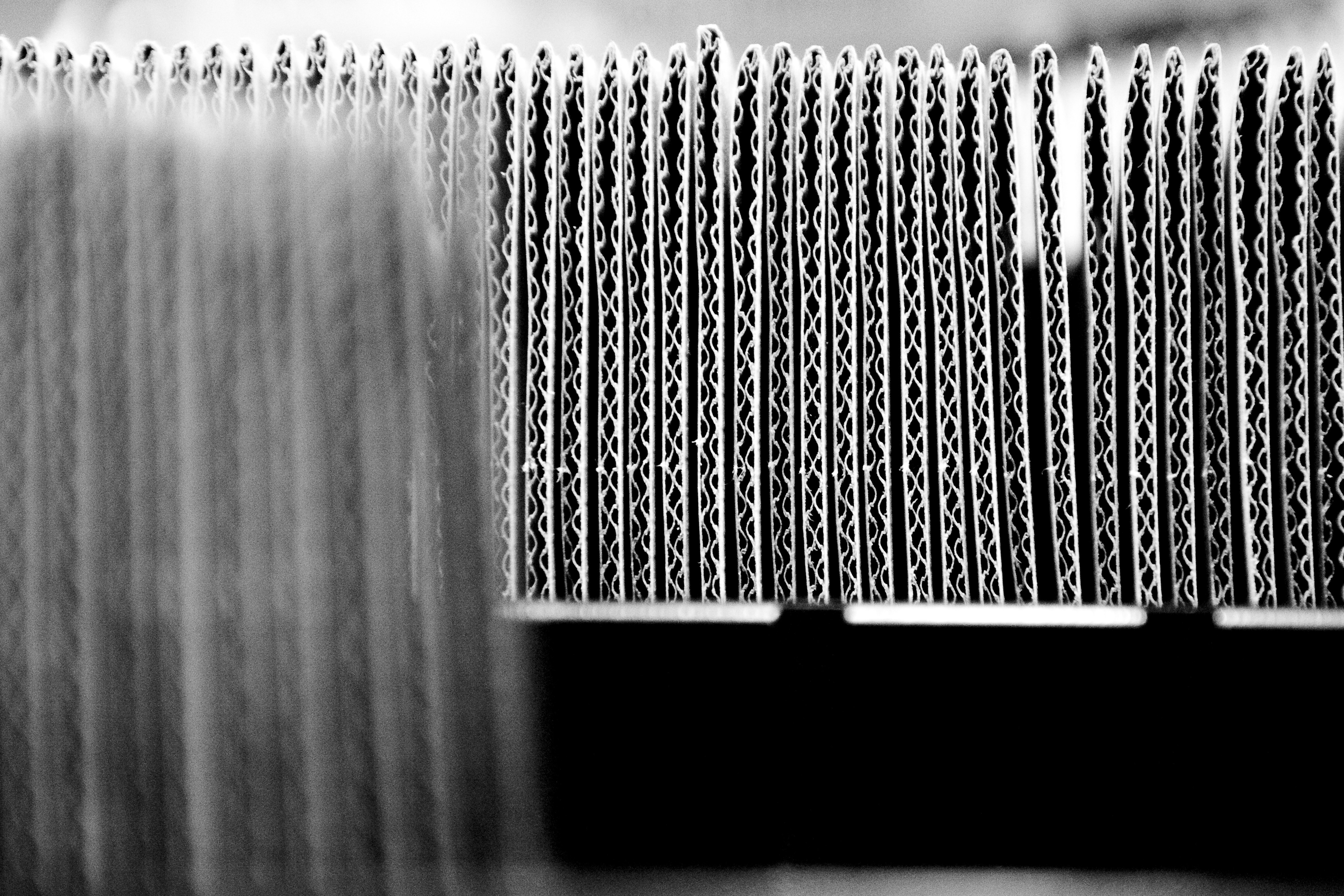 Micro corrugation profile sheets stacked, emphasizing their thinness and versatility.