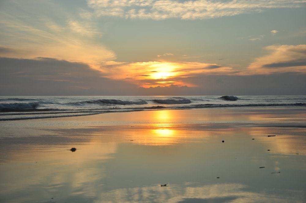 body of water during sunset