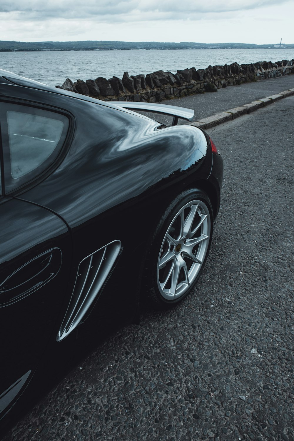 black car on gray asphalt road during daytime