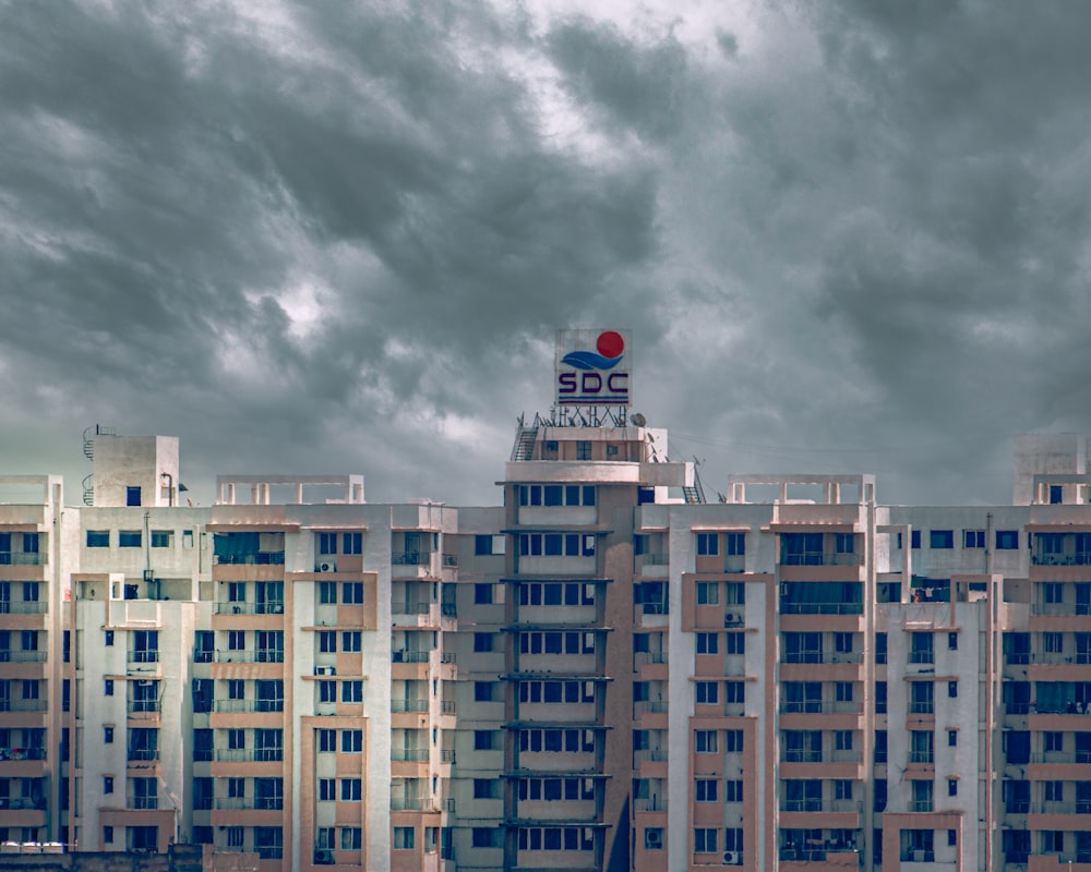 white and blue concrete building under gray clouds during daytime