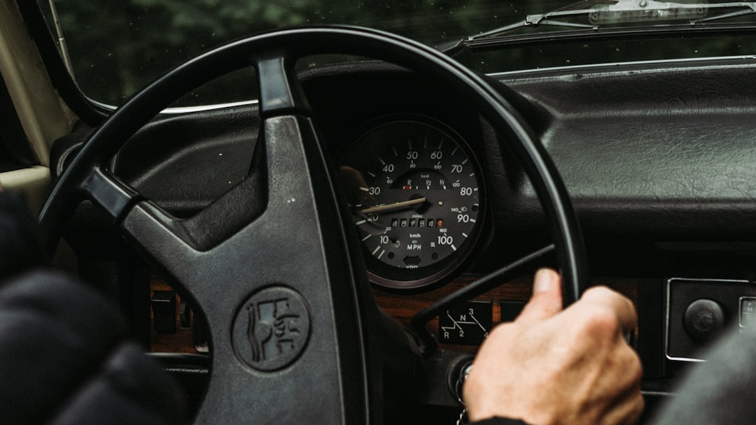 person holding black steering wheel