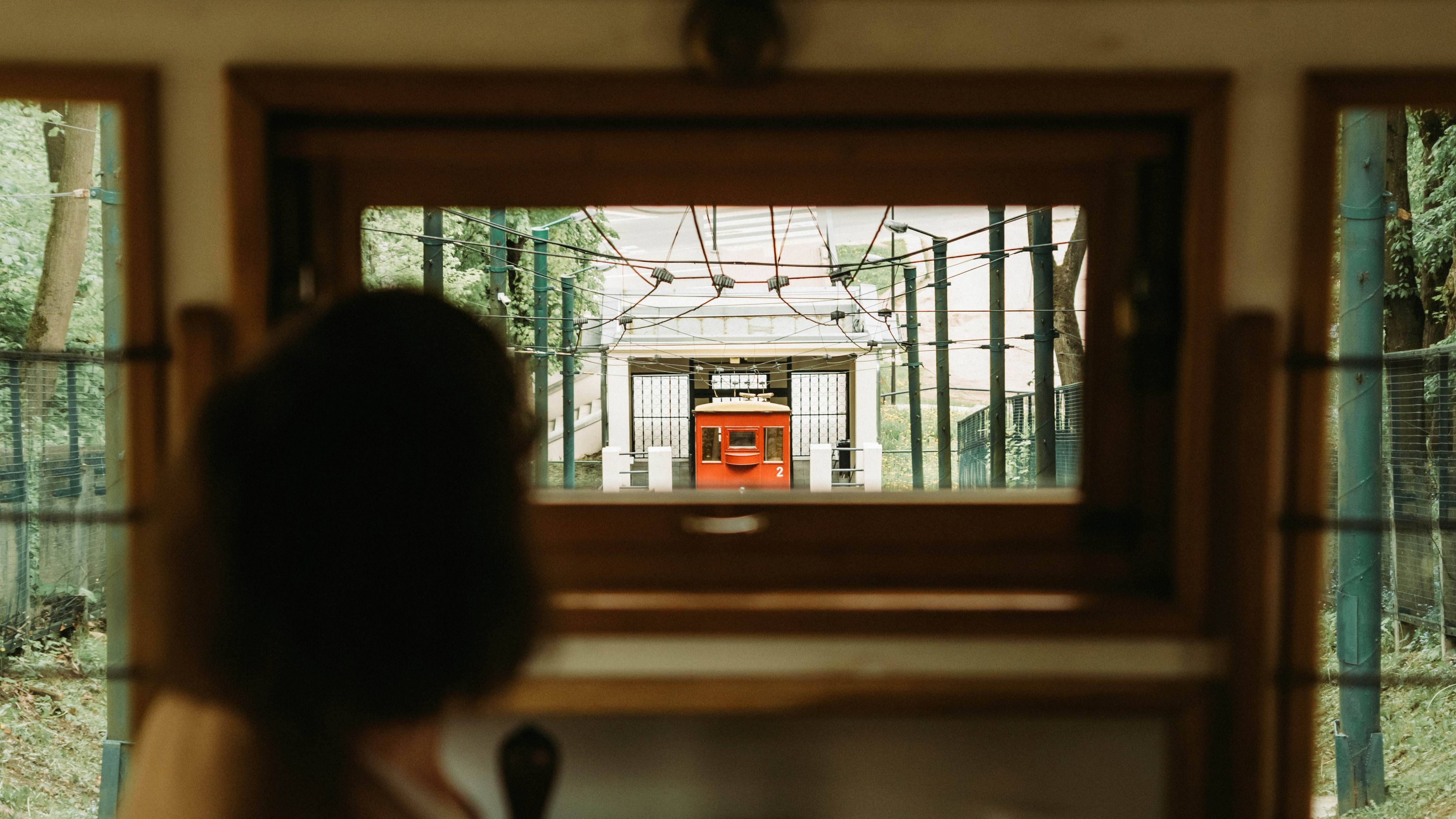 woman in white shirt standing near window