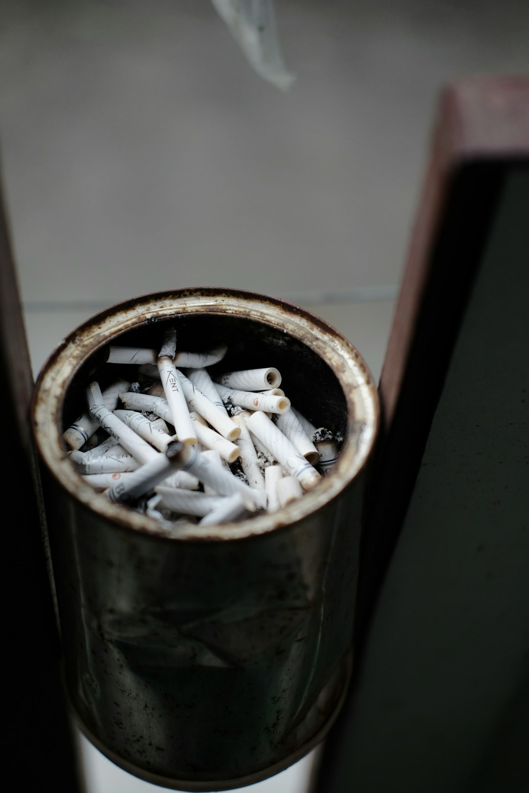 white cigarette butts in brown round container