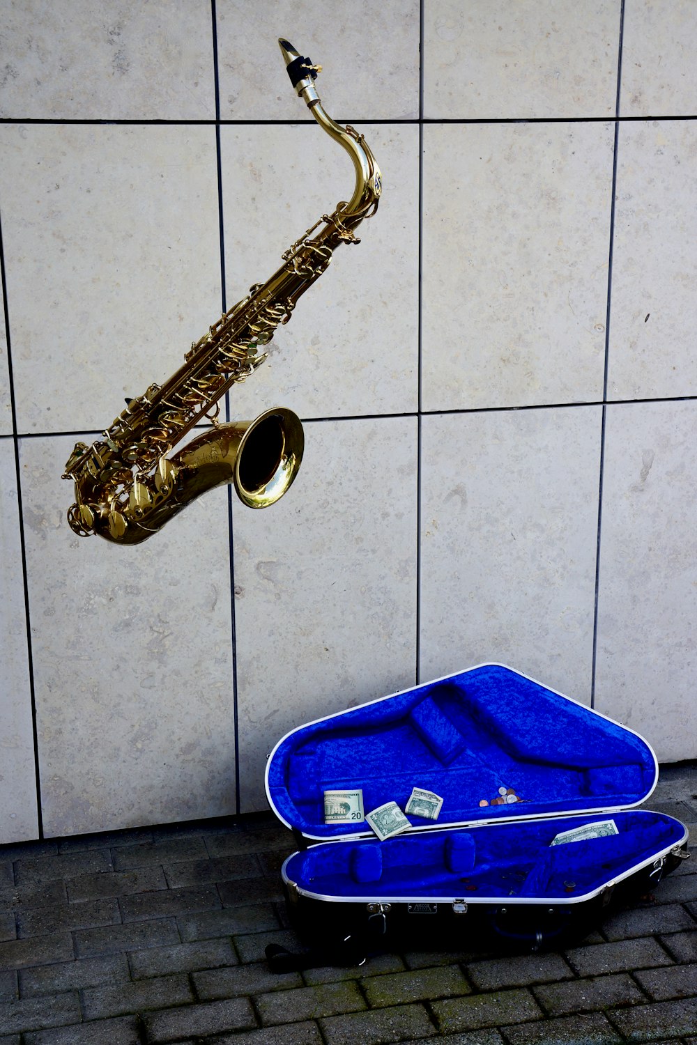 brass saxophone on blue plastic container