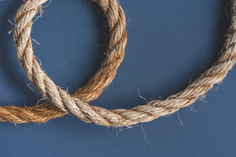 brown rope on blue textile