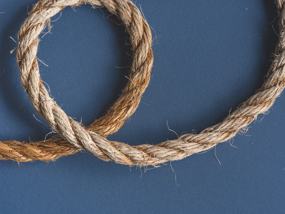 brown rope on blue textile