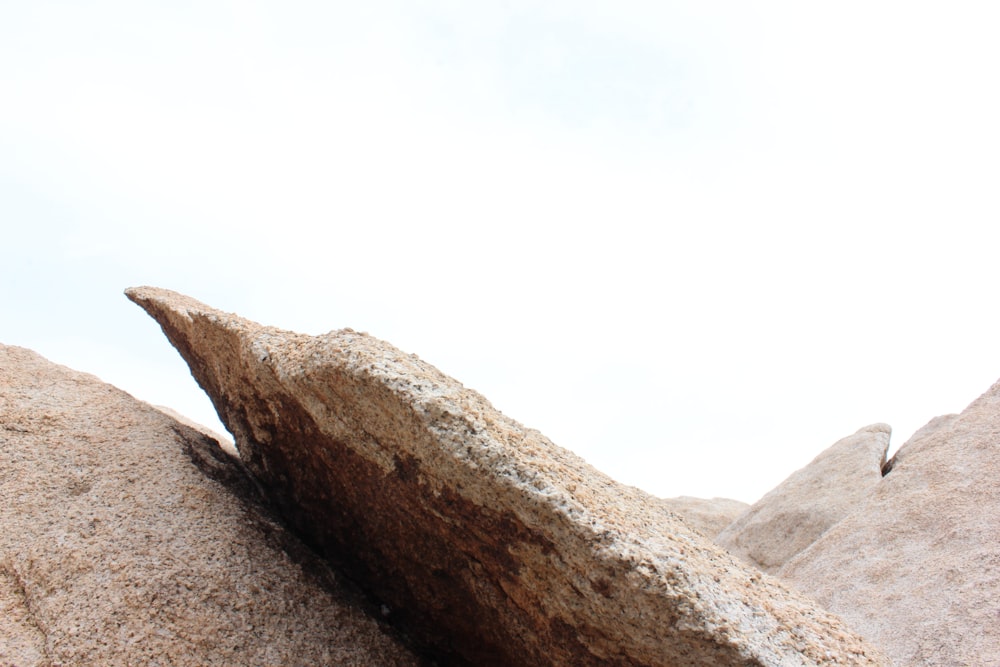 brown rock formation under white sky during daytime