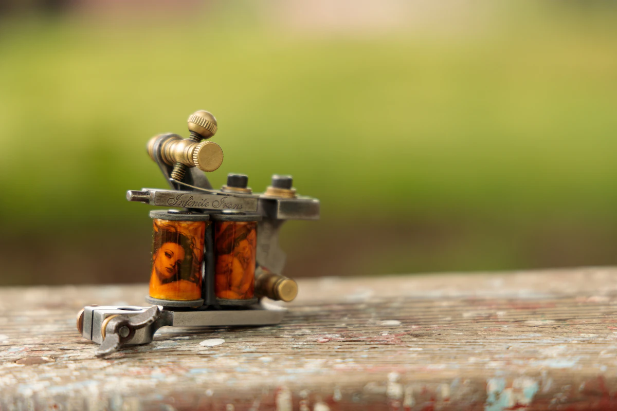 Close-up of tattoo machine working on detailed black-ink design