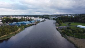 The Damodar river flowing gently beside industrial buildings and greenery in Durgapur