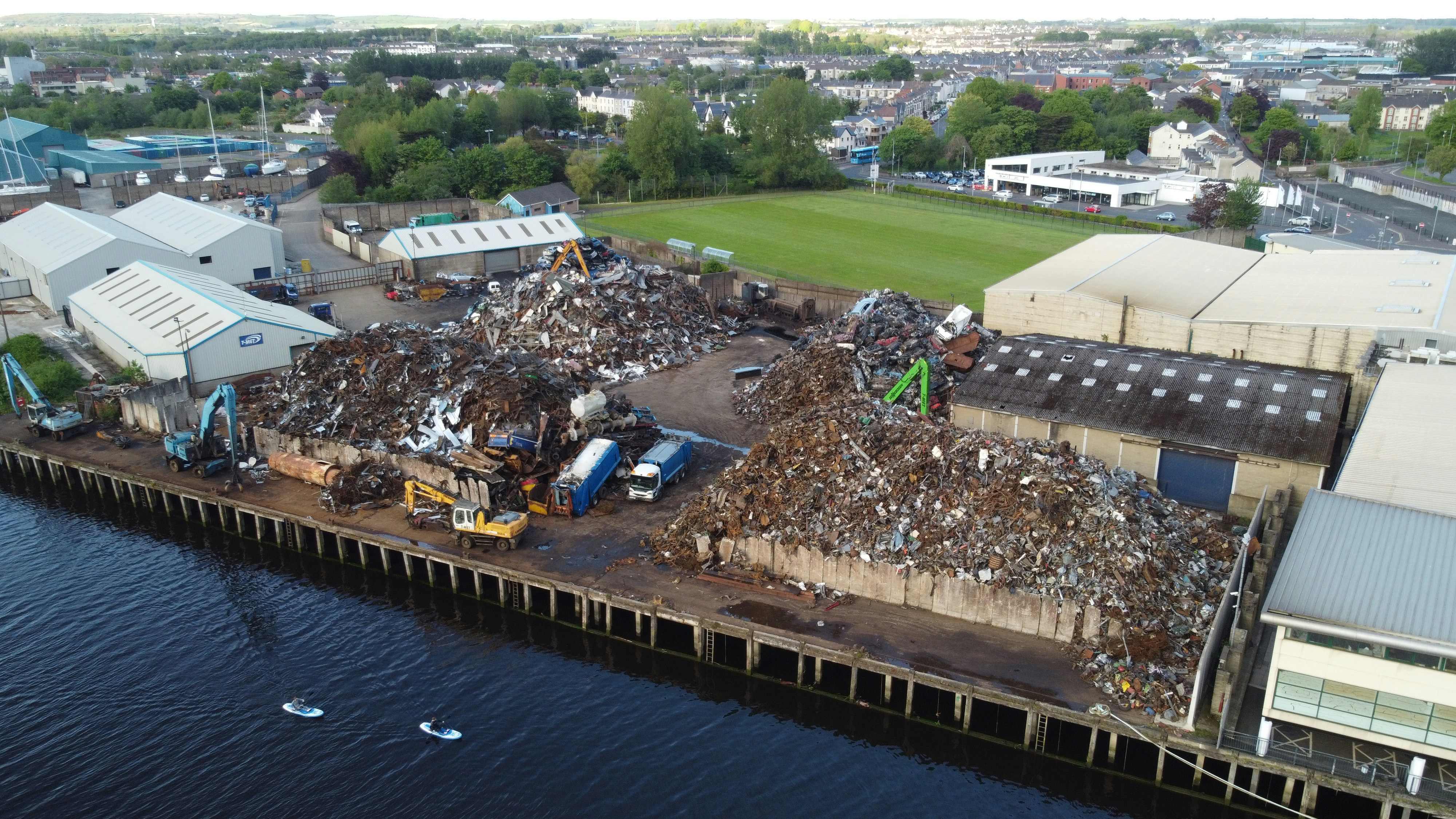 a large pile of trash sitting on top of a pier