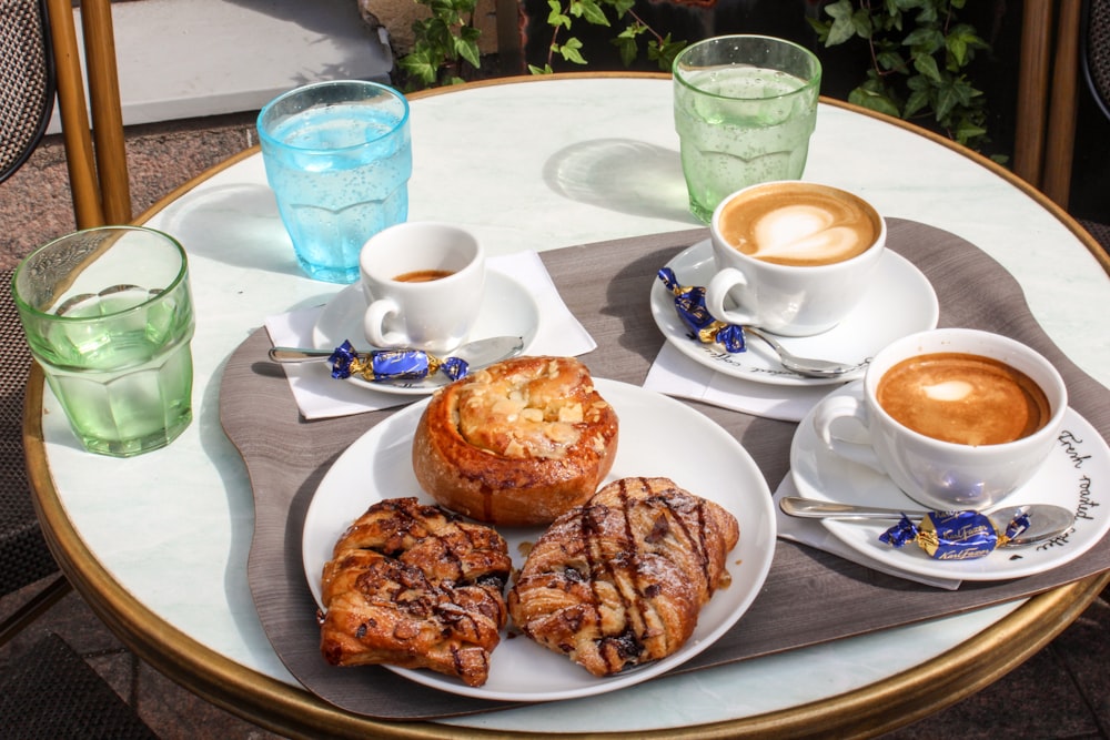 white ceramic cup on white ceramic plate