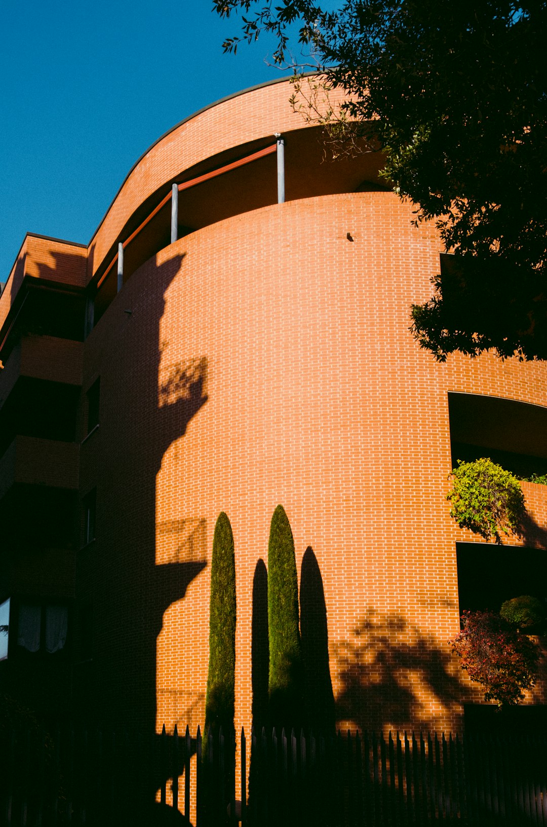 brown concrete building near green trees during daytime