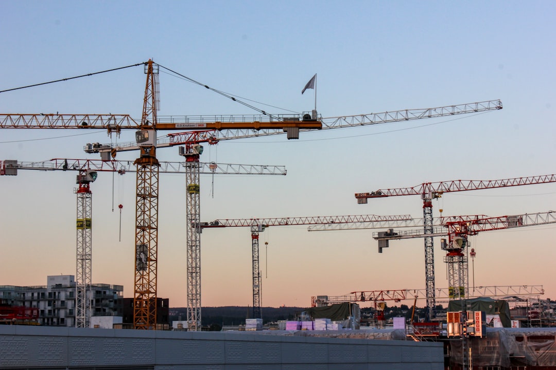 yellow crane under cloudy sky during daytime,