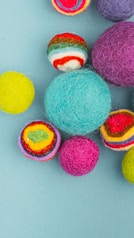 multi colored eggs on white surface