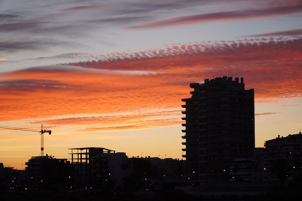 silhouette of city buildings during sunset