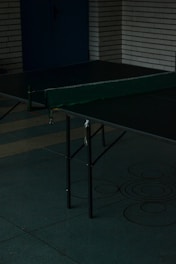 A diverse group of people playing table tennis in a community center.