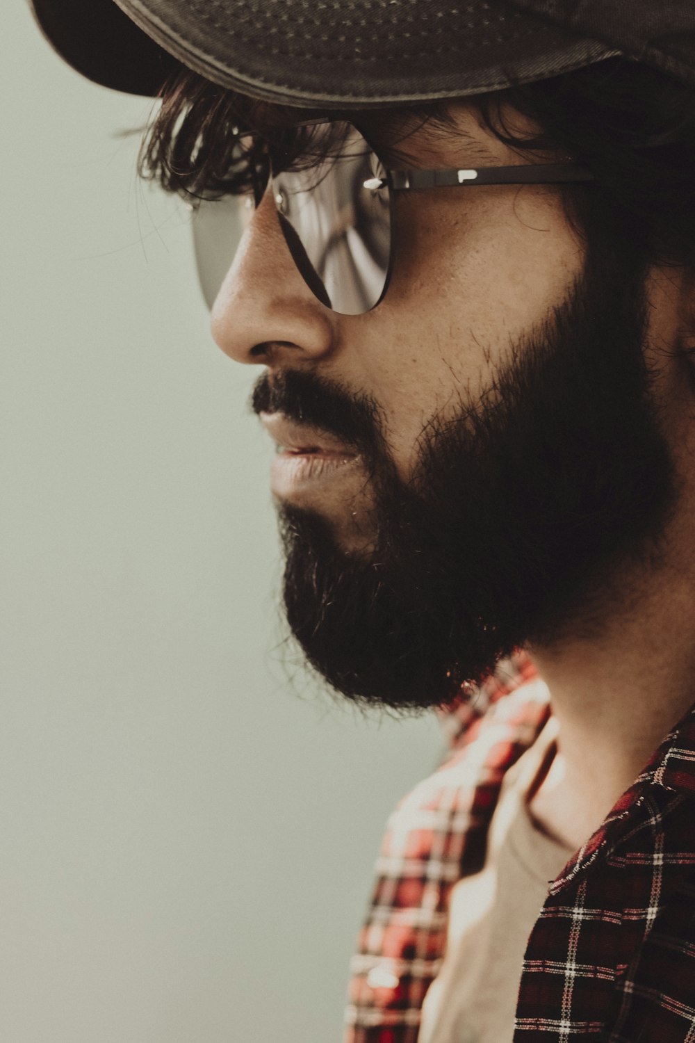 man in red white and black plaid shirt wearing black sunglasses