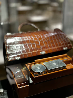 Luxurious leather toiletry bag open to reveal neatly organized compartments.