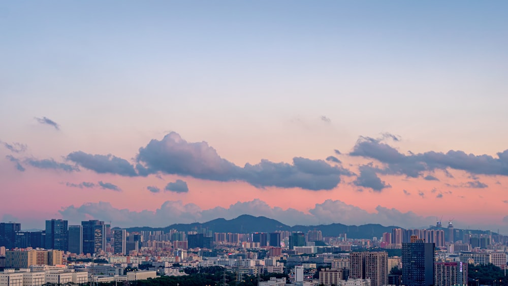 city skyline under cloudy sky during daytime