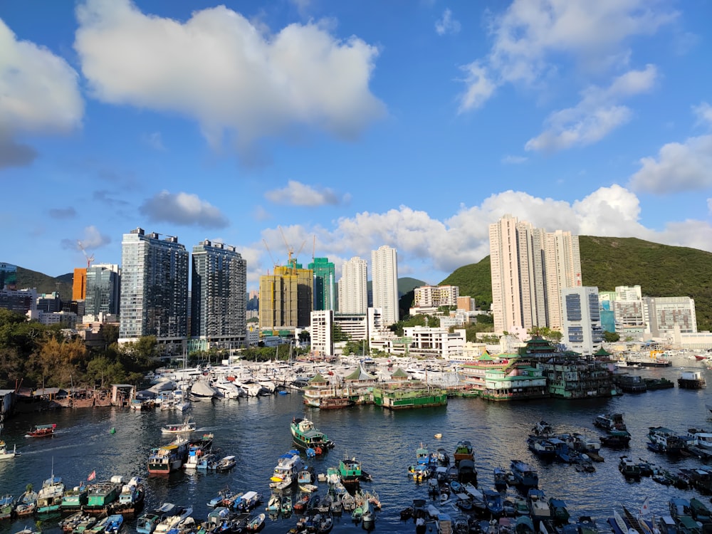 people riding on boat on water near city buildings during daytime