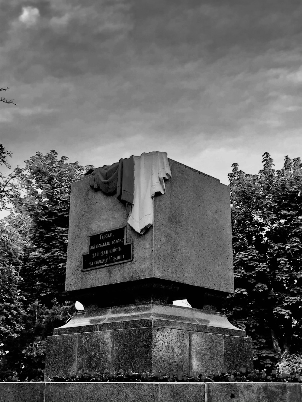 grayscale photo of concrete statue