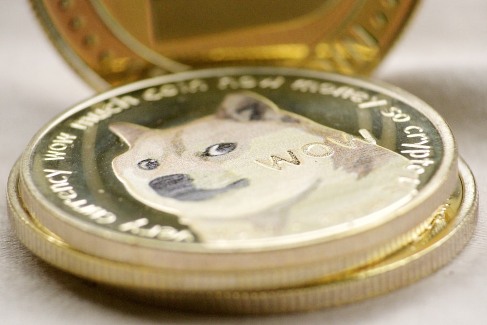 silver round coin on brown wooden table