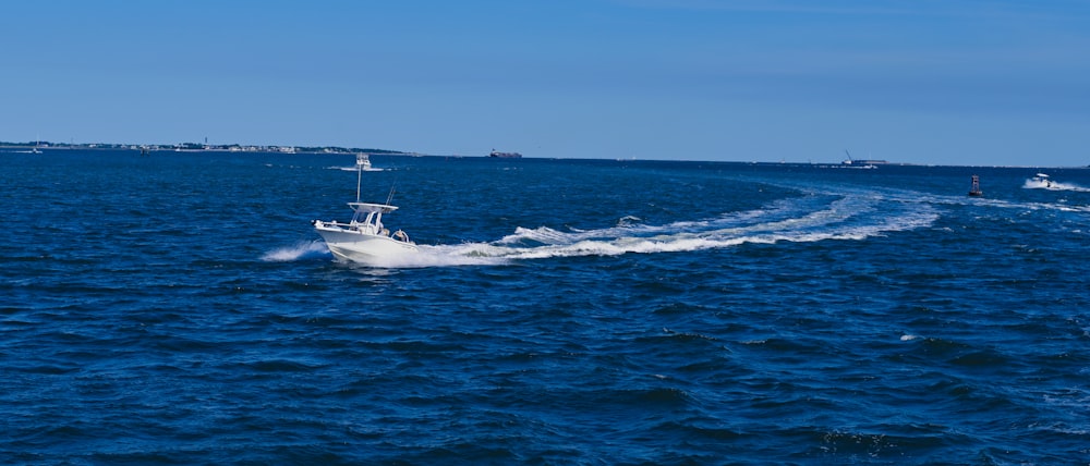 white boat on sea during daytime