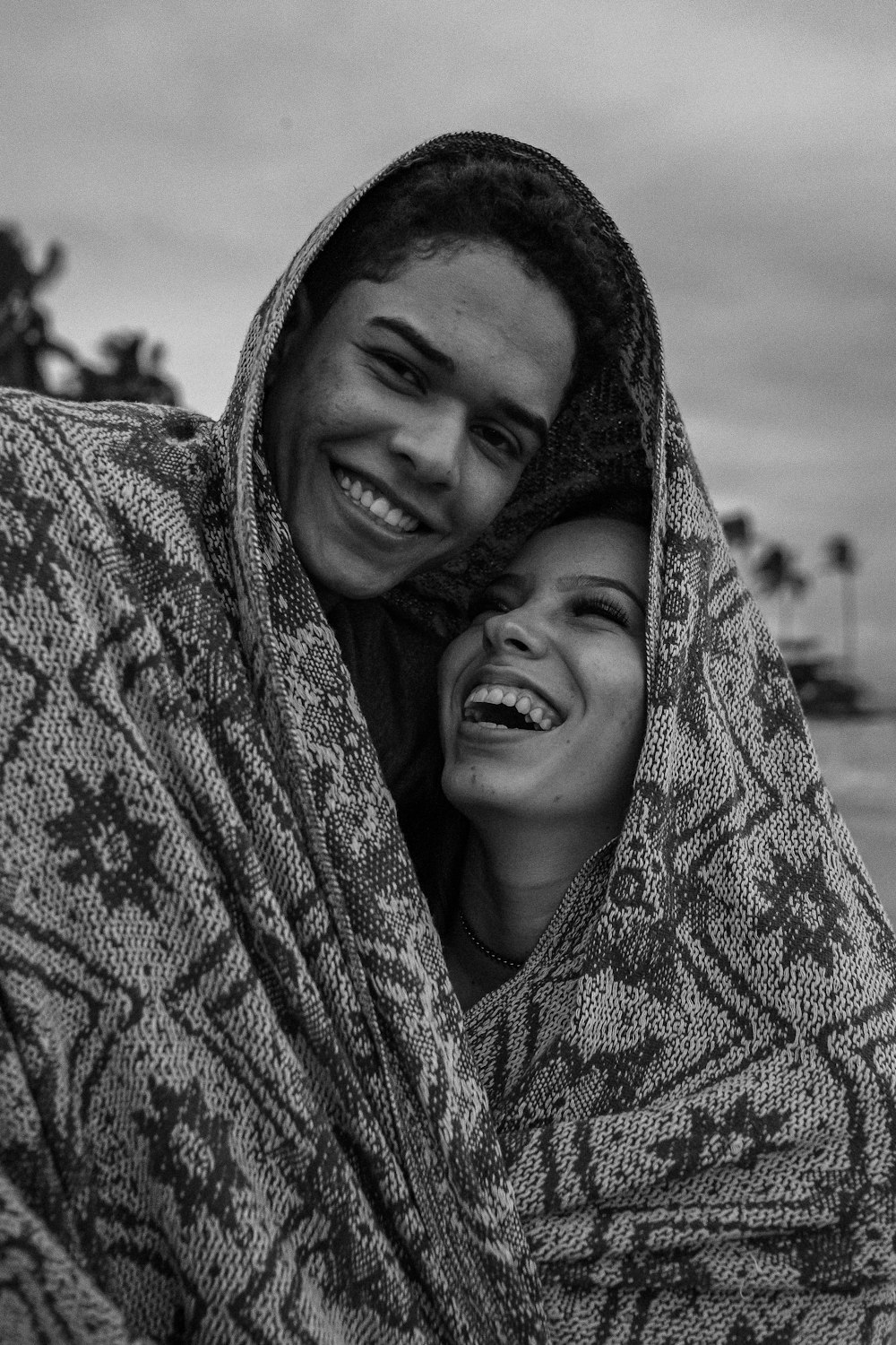 grayscale photo of woman covering her face with scarf