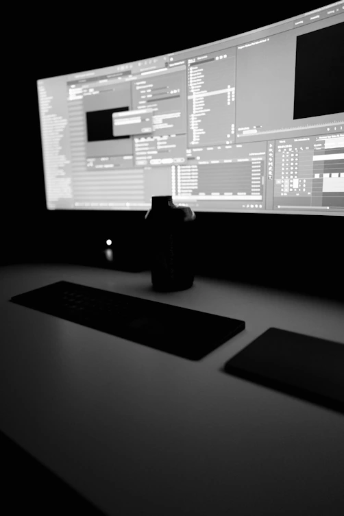 black flat screen computer monitor showing design and schedules beside black computer keyboard