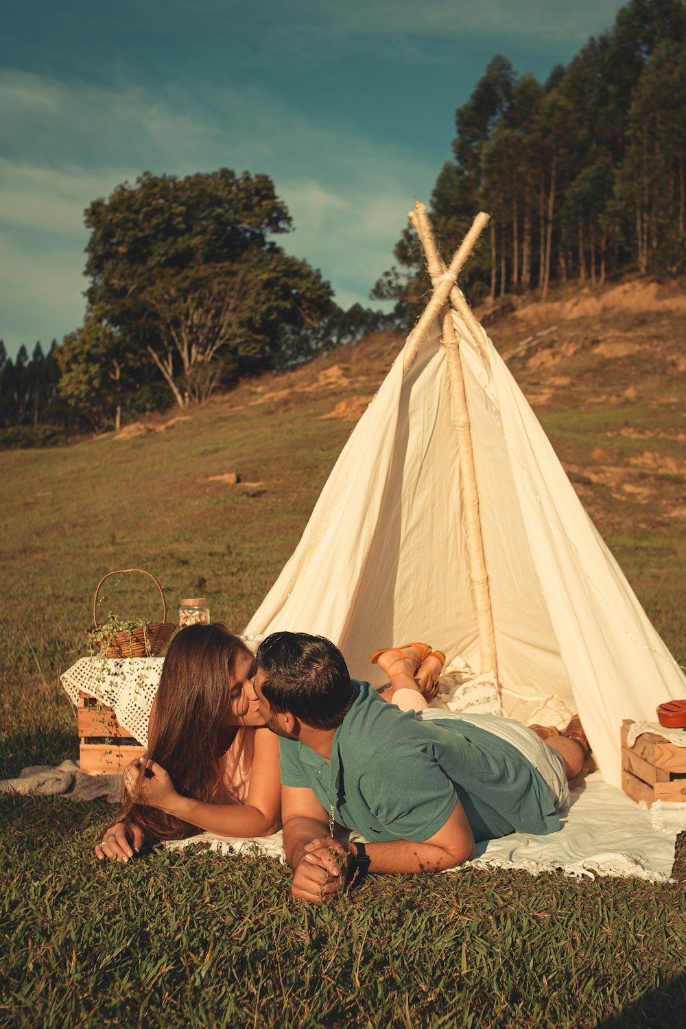 man and woman sitting on white tent during daytime