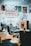 A classic barbershop interior with vintage barber chairs and a traditional red and white striped barber shop sign. The walls are adorned with memorabilia including sports jerseys, posters, and framed photos. The wooden floor and warm lighting create a nostalgic atmosphere.