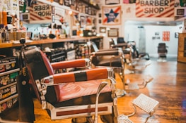 The barbershop interior featuring vintage barber chairs and hair styling products neatly arranged.