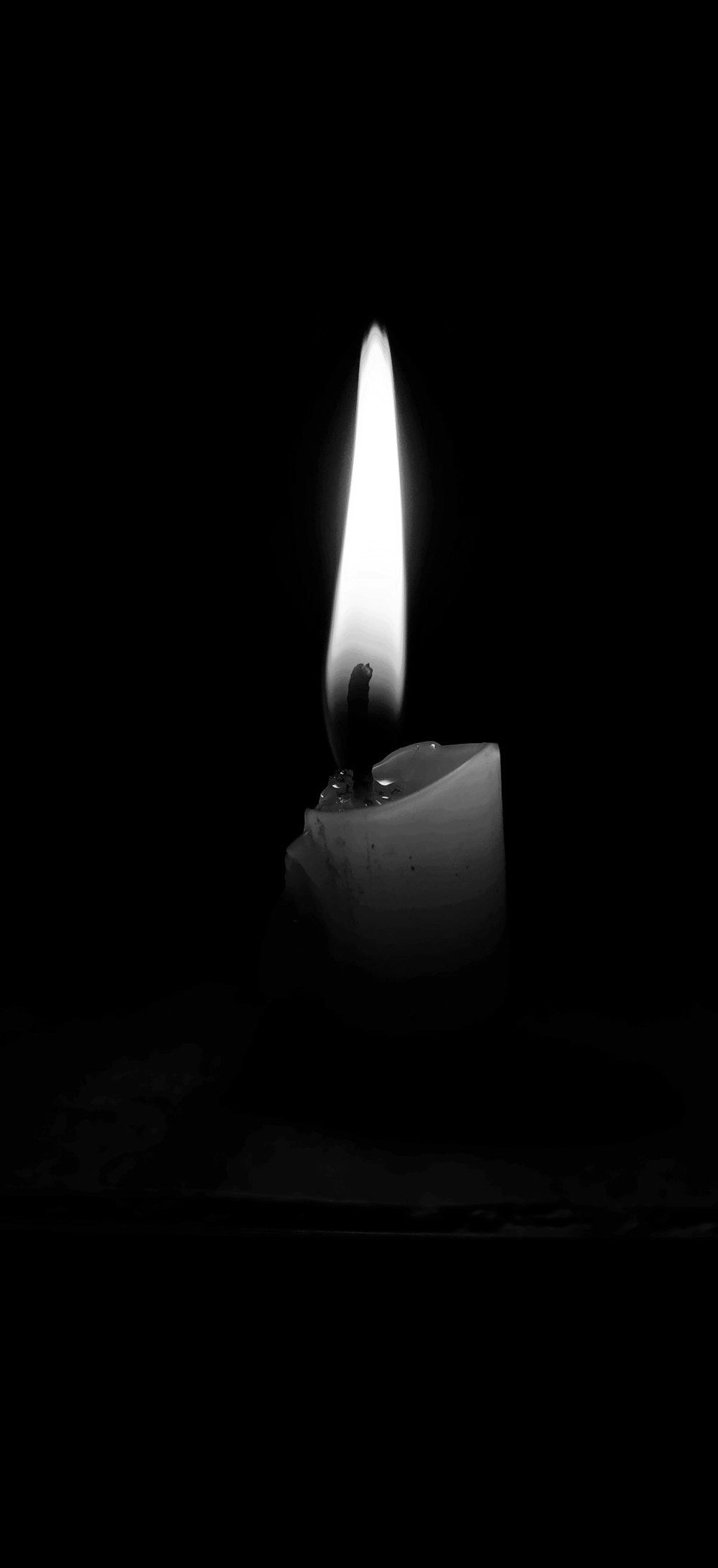 white pillar candle with black background