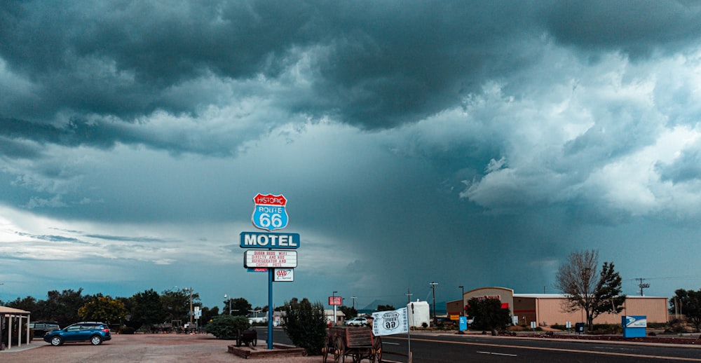 red and white stop sign under gray clouds