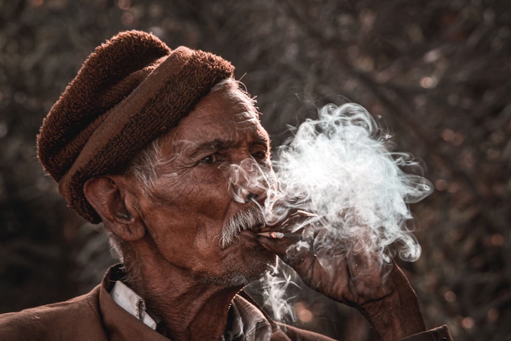 man in brown and white coat smoking