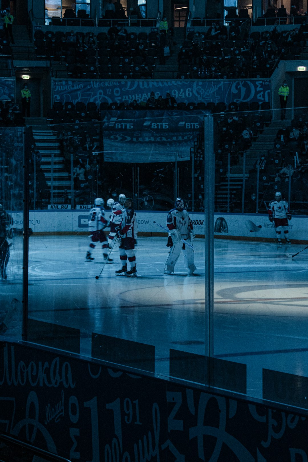 people playing ice hockey in ice stadium