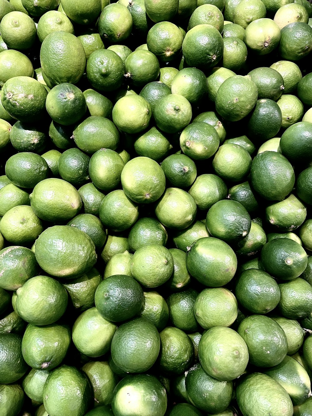 green lime fruit in close up photography