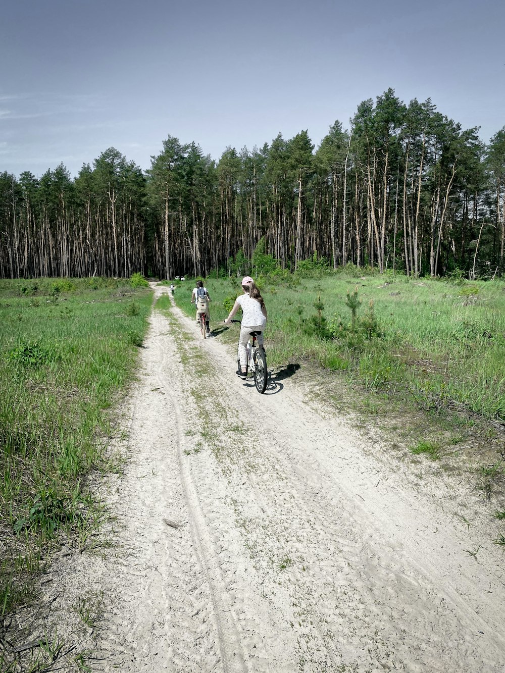 2 people riding motorcycle on dirt road during daytime