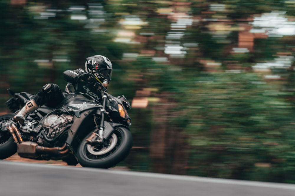 man in black motorcycle helmet riding motorcycle on road during daytime