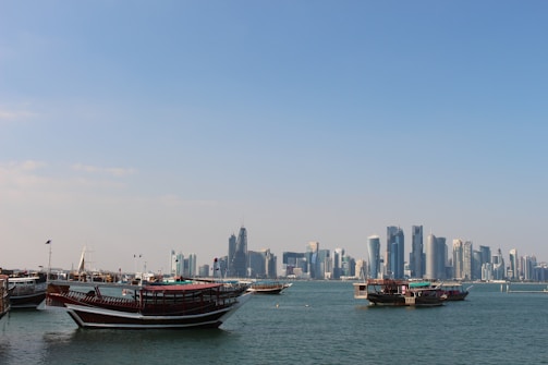 red and black boat on sea during daytime